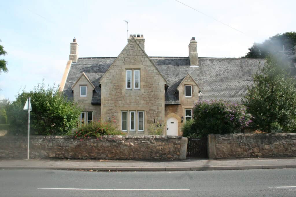 Stone cottage with traditional architecture and landscaped garden in a peaceful neighbourhood.